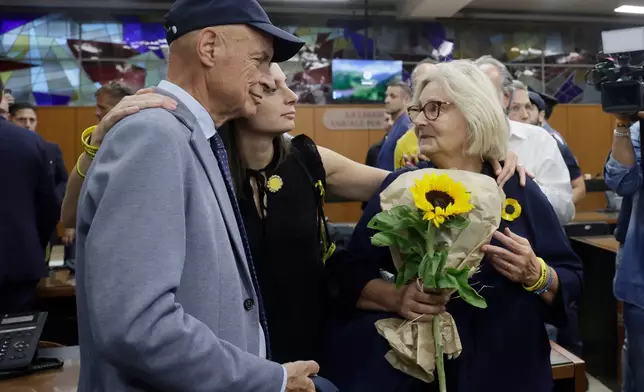 Paola Deffendi, Giulio Regeni's mother, right, her husband Claudio and their daughter Irene, center, embrace after the verdict of a Rome court which convicted three of four Egyptian security officials to 10 years in prison for the abduction and murder of Giulio in Cairo in 2016, in Rome, Monday, Sept. 28, 2026. (Cecilia Fabiano/LaPresse via AP)