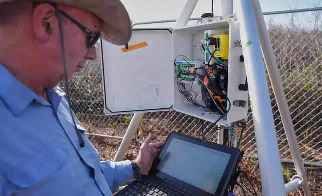 Neal Flanagan, a research scientist at Duke University, displays real-time carbon dioxide emissions from a sensor Wednesday, May 6, 2026, in Belhaven, N.C. (AP Photo/Joshua A. Bickel)