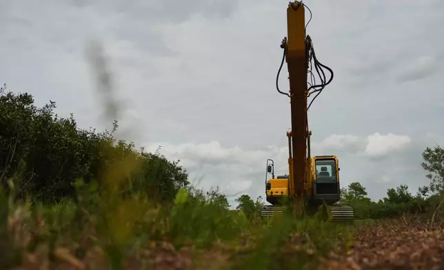A excavator sits near a restoration site Wednesday, May 6, 2026, in Belhaven, N.C. (AP Photo/Joshua A. Bickel)