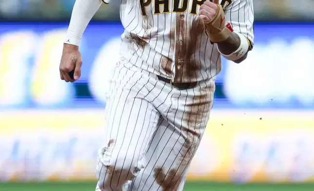 San Diego Padres' Manny Machado runs to third base off Jackson Merrill's single in the first inning of a baseball game against the Arizona Diamondbacks Saturday, Sept. 26, 2026, in San Diego. (AP Photo/Karl Anderson)