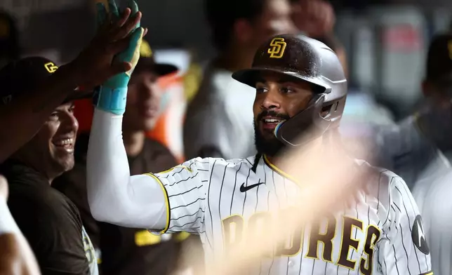 San Diego Padres' Fernando Tatis Jr. celebrates after scoring off Manny Machado's two-run home run in the fourth inning of a baseball game against the Arizona Diamondbacks, Saturday, Sept. 26, 2026, in San Diego. (AP Photo/Karl Anderson)