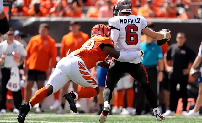 Tampa Bay Buccaneers quarterback Baker Mayfield (6) is sacked by Cincinnati Bengals linebacker Barrett Carter (49) and fumbles the ball in the first half of an NFL football game Sunday, Sept. 13, 2026, in Cincinnati. (AP Photo/Carolyn Kaster)