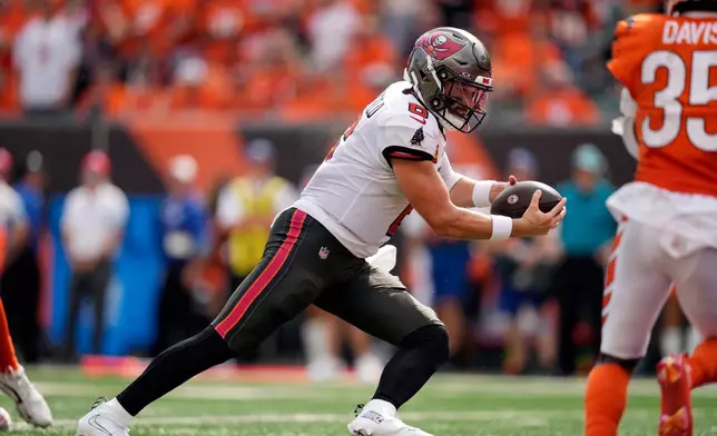 Tampa Bay Buccaneers quarterback Baker Mayfield (6) scores a touchdown on a 9-yard run against the Cincinnati Bengals in the second half of an NFL football game Sunday, Sept. 13, 2026, in Cincinnati. (AP Photo/Carolyn Kaster)