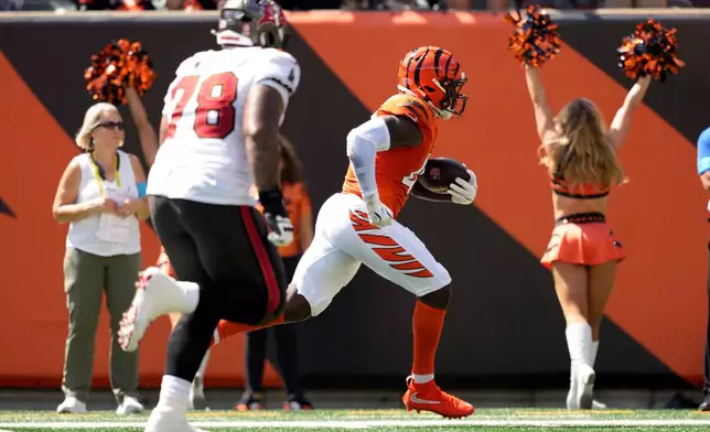 Cincinnati Bengals linebacker Demetrius Knight Jr. (44) runs for a touchdown after recovering a fumble in the first half of an NFL football game against the Tampa Bay Buccaneers Sunday, Sept. 13, 2026, in Cincinnati. (AP Photo/Carolyn Kaster)