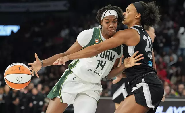 Seattle Storm center Dominique Malonga (14) drives against Las Vegas Aces forward Brianna Turner (21) during the second half of a WNBA basketball game Sunday, Sept. 20, 2026, in Las Vegas. (AP Photo/John Locher)