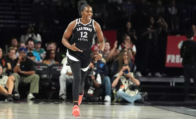 Las Vegas Aces guard Chelsea Gray (12) celebrates after scoring against the Seattle Storm during the second half of a WNBA basketball game Sunday, Sept. 20, 2026, in Las Vegas. (AP Photo/John Locher)