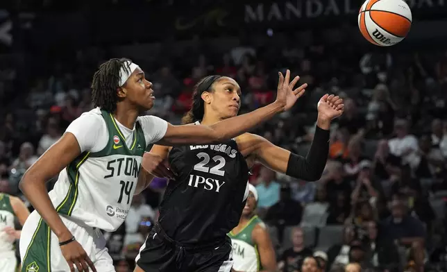Seattle Storm center Dominique Malonga (14) and Las Vegas Aces center A'ja Wilson (22) battle for the ball during the second half of a WNBA basketball game Sunday, Sept. 20, 2026, in Las Vegas. (AP Photo/John Locher)