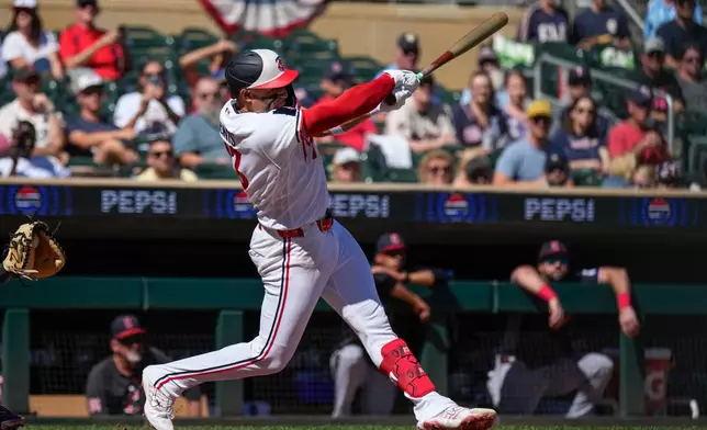 Minnesota Twins' Royce Lewis hits a flyout during the second inning of a baseball game against the Cleveland Guardians, Sunday, Sept. 13, 2026, in Minneapolis. (AP Photo/Joseph Scheller)