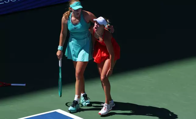 Mirra Andreeva, of Russia, left, helps Anastasia Potapova, of Austria, after Potapova fell during the fourth round of the U.S. Open tennis championships, Monday, Sept. 7, 2026, in New York. (AP Photo/Andres Kudacki)