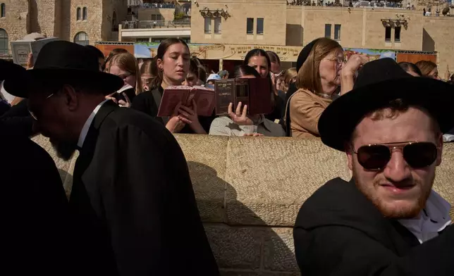 Jewish women pray as they participate in a blessing during the holiday of Sukkot, at the Western Wall, the holiest site where Jews can pray, in the Old City of Jerusalem, Monday, Sept. 28, 2026. (AP Photo/Leo Correa)