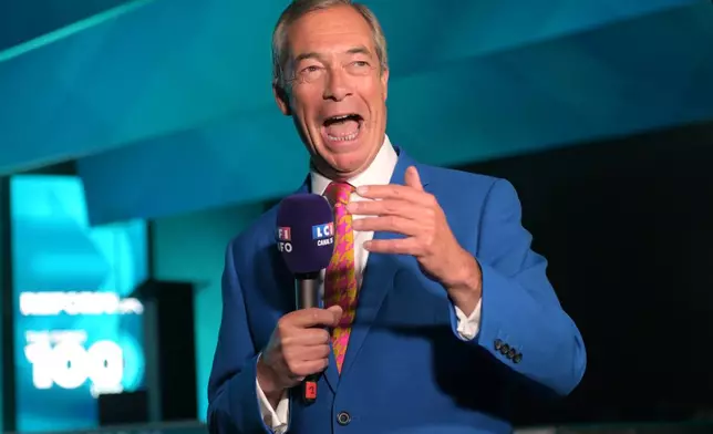 Reform party leader Nigel Farage speaks to the media during the Reform party's annual conference at the National Exhibition Centre in Birmingham, England, Friday, Sept. 4, 2026. (AP Photo/Thomas Krych)