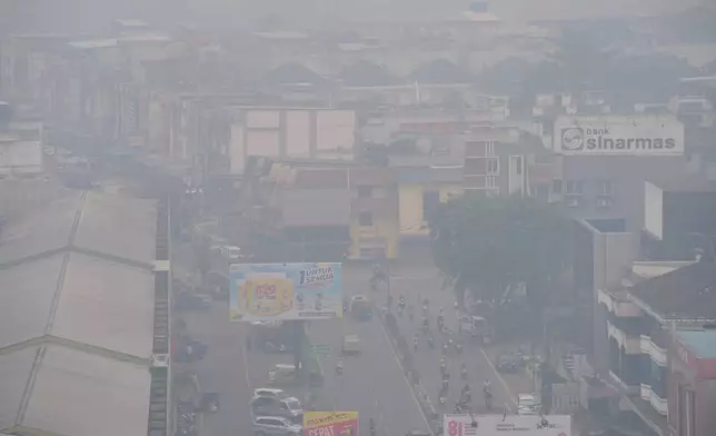 Thick haze from forest fires blanket the city of Pontianak in West Kalimantan, Indonesia, Monday, Sept. 14, 2026. (AP Photo/Tatan Syuflana)