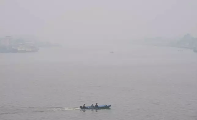A boat cruises on Kapuas River amid the thick haze from forest fires, in Pontianak, West Kalimantan, Indonesia, Monday, Sept. 14, 2026. (AP Photo/Tatan Syuflana)