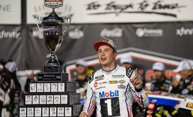 Christopher Bell celebrates in Victory Lane after winning a NASCAR Cup Series auto race Sunday, Sept. 6, 2026, in Darlington, S.C. (AP Photo/Matt Kelley)
