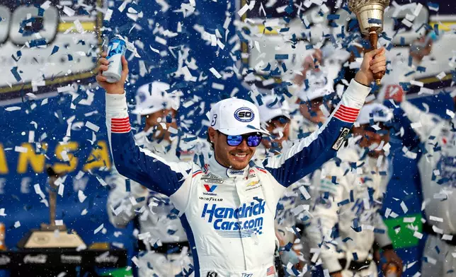 Kyle Larson celebrates in Victory Lane after winning a NASCAR Cup Series auto race in Kansas City, Kan., Sunday, Sept. 27, 2026. (AP Photo/Colin E. Braley)