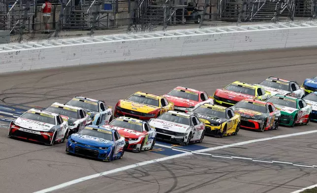 Denny Hamlin, front left, and Kyle Larson, front right, lead other drivers at the start of the second stage during a NASCAR Cup Series auto race in Kansas City, Kan., Sunday, Sept. 27, 2026. (AP Photo/Colin E. Braley)