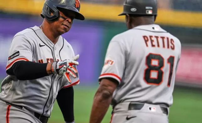 San Francisco Giants' Rafael Devers, left, is greeted by third base coach Gary Bettis (81) after hitting a solo home run off Pittsburgh Pirates pitcher Bubba Chandler during the first inning of a baseball game in Pittsburgh, Wednesday, Sept. 2, 2026. (AP Photo/Gene J. Puskar)