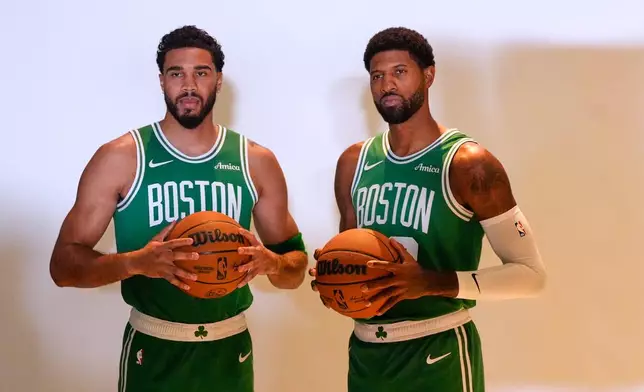 Boston Celtics' Jayson Tatum, left, and Paul George, right, pose together during the NBA basketball team's media day, Monday, Sept. 28, 2026, in Boston. (AP Photo/Charles Krupa)