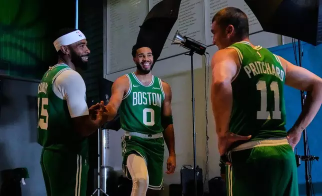 Boston Celtics' Jayson Tatum, center, talks with teammates Mike Conley, left, and Payton Pritchard (11) during the NBA basketball team's media day, Monday, Sept. 28, 2026, in Boston. (AP Photo/Charles Krupa)