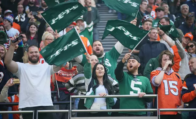 FILE - New York Jets fans cheer during the first half of an NFL football game against the Denver Broncos on Oct. 12, 2025, in London. (AP Photo/Kin Cheung, File)