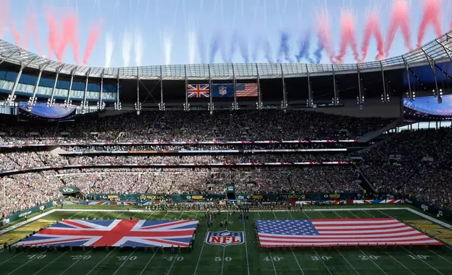 FILE - The Union Jack and United States flags are presented on the field during the singing of the national anthem before an NFL football game between the Green Bay Packers and the New York Giants at Tottenham Hotspur Stadium in London, Oct. 9, 2022. (AP Photo/Steve Luciano, File)