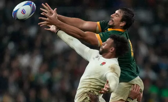 FILE - England's Courtney Lawes, left, and South Africa's Eben Etzebeth battle for the ball during the Rugby World Cup semifinal match between England and South Africa at the Stade de France in Saint-Denis, outside Paris, Oct. 21, 2023. (AP Photo/Thibault Camus, File)