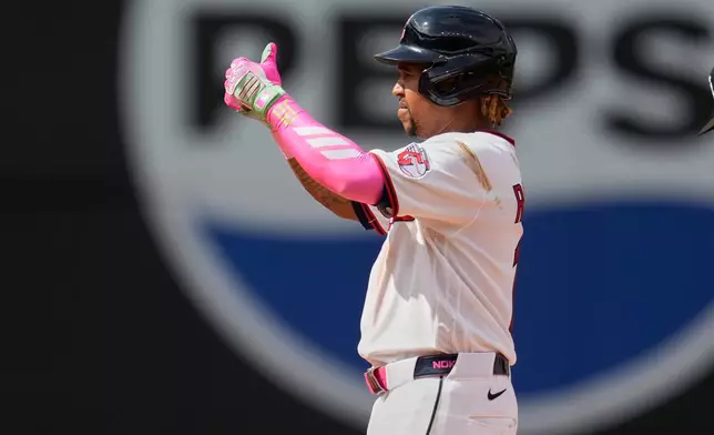Cleveland Guardians' José Ramírez gestures from second base after hitting a double in the fifth inning of a baseball game against the Chicago White Sox in Cleveland, Wednesday, Sept. 16, 2026. (AP Photo/Sue Ogrocki)