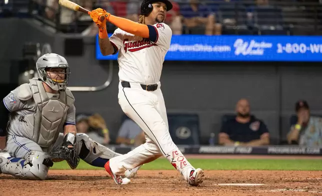 Cleveland Guardians' Jose Ramirez watches his fly out off Toronto Blue Jays starting pitcher Dylan Cease as cacher Alejandro Kirk looks on during the sixth inning of a baseball game, Wednesday, Sep. 2, 2026, in Cleveland. (AP Photo/Phil Long)