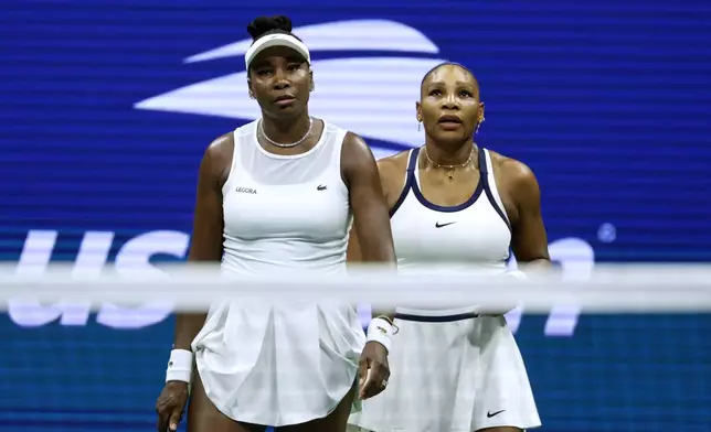 Venus Williams, left, and Serena Williams, of the United States, look on as they play against Hao-Ching Chan, of Taiwan, and Maya Joint, of Australia, during a women's doubles match at the U.S. Open tennis championships, Friday, Sept. 4, 2026, in New York. (AP Photo/Adam Hunger)