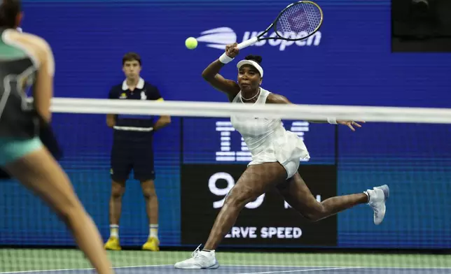 Venus Williams, of the United States, hits a return as she plays a women's doubles match with partner Serena Williams against Hao-Ching Chan, of Taiwan, and Maya Joint, at the U.S. Open tennis championships, Friday, Sept. 4, 2026, in New York. (AP Photo/Adam Hunger)