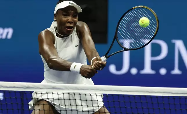 Venus Williams, of the United States, hits a return as she plays a women's doubles match with partner Serena Williams against Hao-Ching Chan, of Taiwan, and Maya Joint, at the U.S. Open tennis championships, Friday, Sept. 4, 2026, in New York. (AP Photo/Adam Hunger)