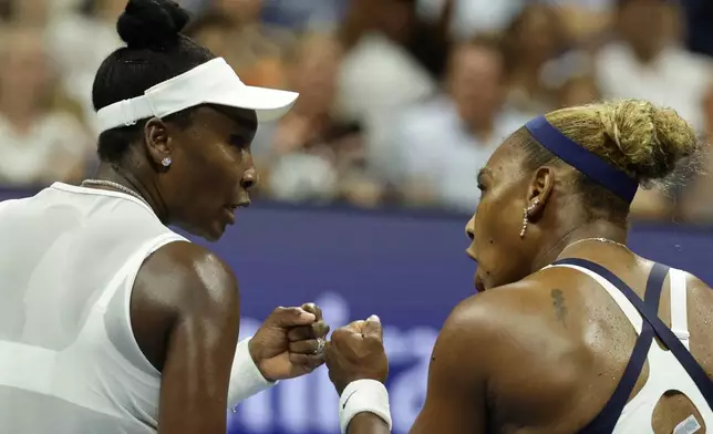Venus Williams, right, and Serena Williams, of the United States, fist bump during the third set as they play against Hao-Ching Chan, of Taiwan, and Maya Joint, of Australia, during a women's doubles match at the U.S. Open tennis championships, Friday, Sept. 4, 2026, in New York. (AP Photo/Adam Hunger)