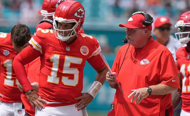 Kansas City Chiefs quarterback Patrick Mahomes (15) talks with Kansas City Chiefs head coach Andy Reid during an NFL football game against the Miami Dolphins, Sunday, Sept. 27, 2026, in Miami Gardens. (AP Photo/Lynne Sladky)