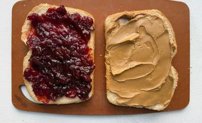 A peanut butter and jelly sandwich is prepared in New York in August 2026. (Katie Workman via AP)