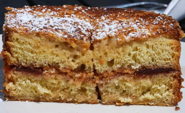 A griddled peanut butter and jelly sandwich, made with sourdough bread that is crusted in Frosted Flakes, appears at South Philadelphia Tap Room's in Philadelphia, Wednesday, Aug. 12, 2026. (AP Photo/Matt Rourke)