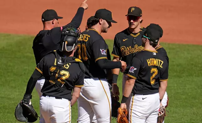Pittsburgh Pirates pitcher Paul Skenes, center, is removed from the game by manager Don Kelly, rear left, during the seventh inning of a baseball game against the St. Louis Cardinals in Pittsburgh, Thursday, Sept. 24, 2026. (AP Photo/Gene J. Puskar)