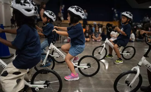 Students participate in a learn-to-ride program at Terra Vista Elementary School in Rancho Cucamonga, Calif., Wednesday, Sept. 2, 2026.(AP Photo/Jae C. Hong)