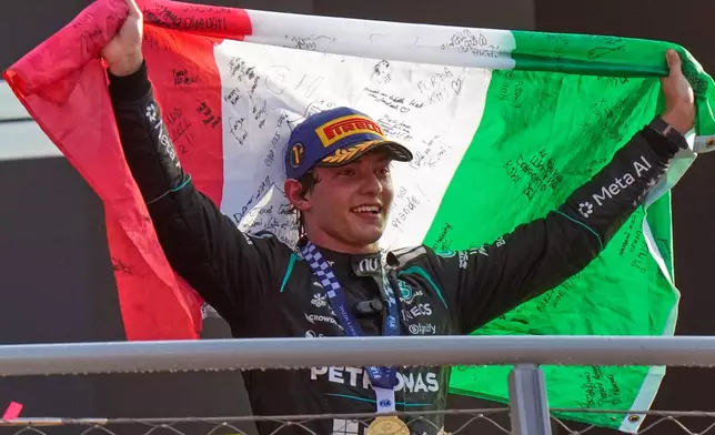 Mercedes driver Andrea Kimi Antonelli of Italy celebrates on the podium after winning the Italian Formula One Grand Prix race, in Monza, Italy, Sunday, Sept. 6, 2026. (AP Photo/Luca Bruno)