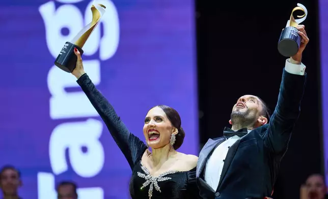 Nair Schinca and Nicolas Schell celebrate after winning the stage category at the Tango World Championship in Buenos Aires, Argentina, Wednesday, Sept. 2, 2026. (AP Photo/Rodrigo Abd)