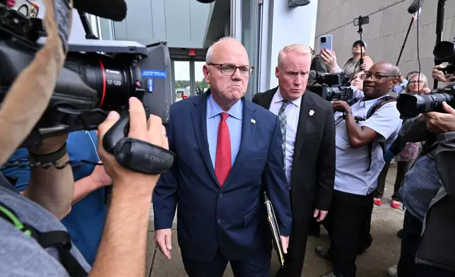 Timothy Cruz, Plymouth County District Attorney, center, leaves Plymouth Superior Court, Thursday, Sept. 3, 2026, in Plymouth, Mass. (AP Photo/Josh Reynolds )