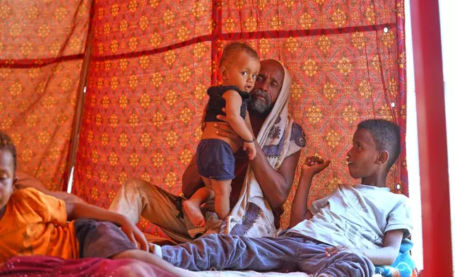 Displaced Yemenis sit at their tent at Al-Firdaws camp in Ras Imran, just outside Aden, Yemen, Monday, Sept. 14, 2026. (AP Photo/Abdulnasser Alseddik)