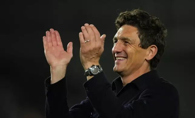 Brentford's head coach Keith Andrews wlaks off the pitch after the Premier League soccer match between Brentford and Chelsea in London, England, Friday, Sept. 18, 2026. (AP Photo/Dave Shopland)