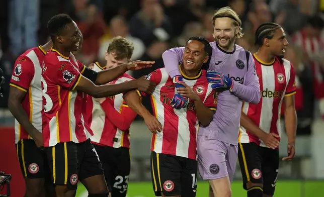 Brentford players celebrate after the Premier League soccer match between Brentford and Chelsea in London, England, Friday, Sept. 18, 2026. (AP Photo/Dave Shopland)