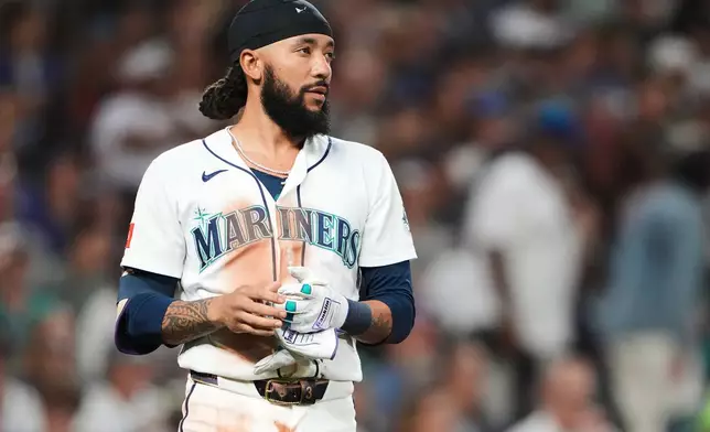 Seattle Mariners' J.P. Crawford looks on after being called out on strikes to end the fourth inning of a baseball game against the Athletics, Saturday, Sept. 5, 2026, in Seattle. (AP Photo/Lindsey Wasson)