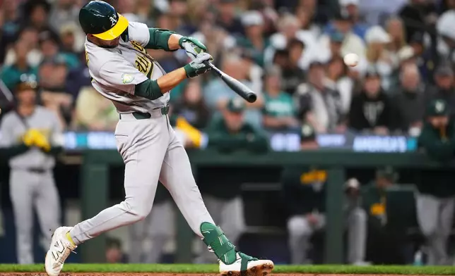 Athletics' Max Muncy hits an RBI single during the fourth inning of a baseball game against the Seattle Mariners, Saturday, Sept. 5, 2026, in Seattle. (AP Photo/Lindsey Wasson)