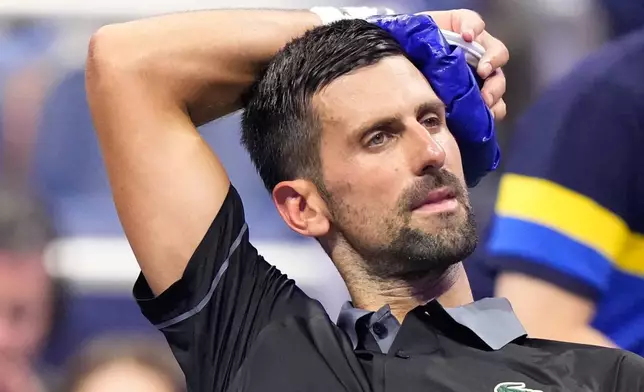 Novak Djokovic, of Serbia, cools off during a match against Mariano Navone, of Argentina, in the first round of the U.S. Open tennis championships Sunday, Aug. 30, 2026, in New York. (AP Photo/Frank Franklin II)