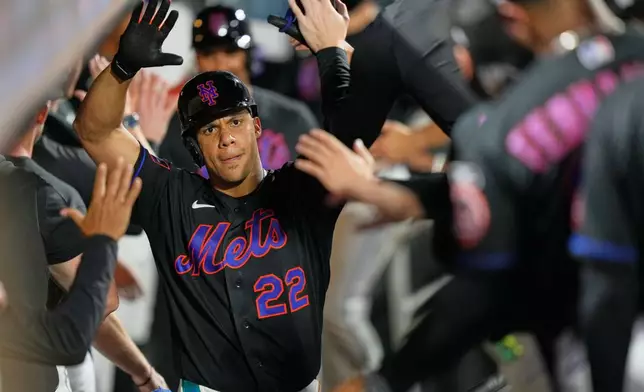 New York Mets' Juan Soto celebrates his three-run home run in the dugout during the sixth inning of a baseball game against the Philadelphia Phillies, Friday, Sept. 18, 2026, in New York. (AP Photo/Seth Wenig)