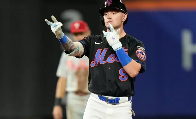 New York Mets' A.J. Ewing reacts after hitting a two-run double during the first inning of a baseball game against the Philadelphia Phillies, Friday, Sept. 18, 2026, in New York. (AP Photo/Seth Wenig)