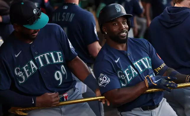 Seattle Mariners' Randy Arozarena, right, celebrates with Lazaro Montes (99) after hitting a three-run home run during the second inning of a baseball game against the Athletics, Saturday, Sept. 12, 2026, in West Sacramento, Calif. (AP Photo/Sara Nevis)