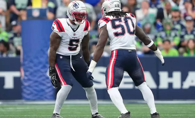 New England Patriots linebacker Gabe Jacas (50) celebrates sacking Seattle Seahawks quarterback Drew Lock with New England Patriots linebacker Dre'mont Jones (5) during the first half of an NFL football game, Wednesday, Sept. 9, 2026, in Seattle. (AP Photo/Lindsey Wasson)